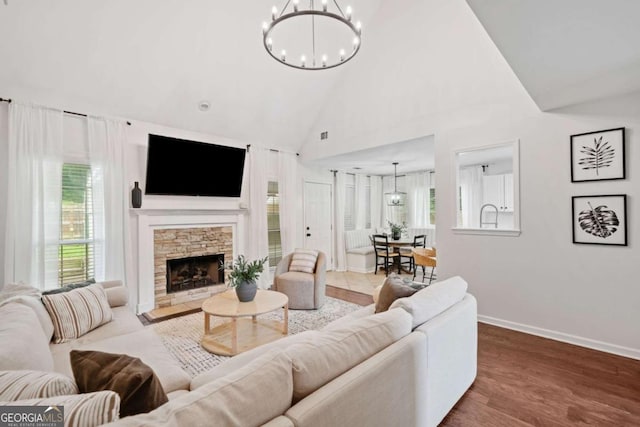 1825 Millstone Ct, Alpharetta, GA 30004 - living room with a chandelier, a fireplace, wood finished floors, and high vaulted ceiling