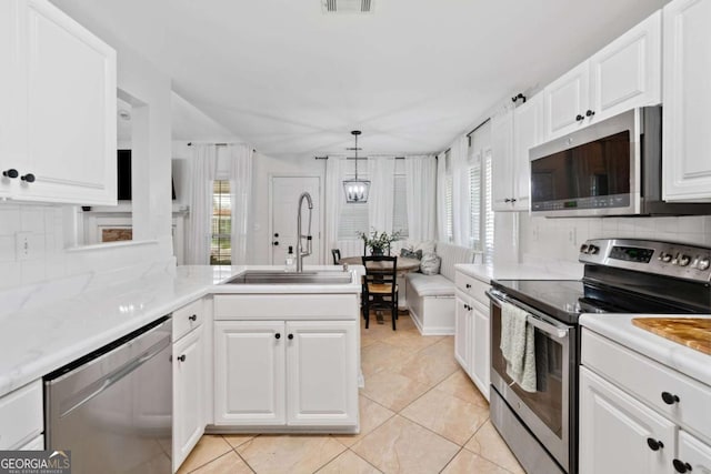 1825 Millstone Ct, Alpharetta, GA 30004 - kitchen with stainless steel appliances, tasteful backsplash, white cabinets, light tile patterned floors, and a peninsula