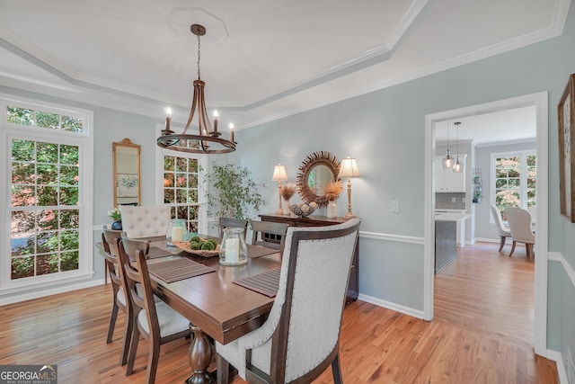 100 Castlebrook Chase, Tyrone, GA 30290 - dining area featuring a chandelier, a raised ceiling, light wood-style floors, and ornamental molding