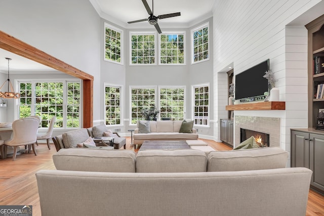 100 Castlebrook Chase, Tyrone, GA 30290 - living area with ornamental molding, a large fireplace, ceiling fan, healthy amount of natural light, and a towering ceiling