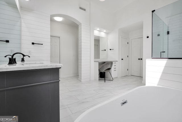 100 Castlebrook Chase, Tyrone, GA 30290 - bathroom with a freestanding tub, vanity, and marble look tile flooring