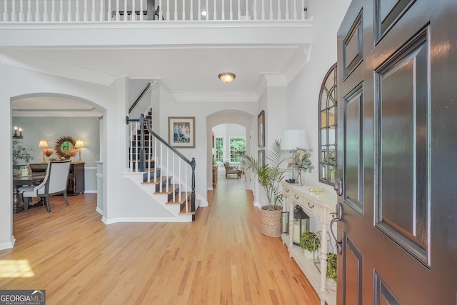 100 Castlebrook Chase, Tyrone, GA 30290 - foyer with arched walkways, stairway, light wood-style floors, and crown molding