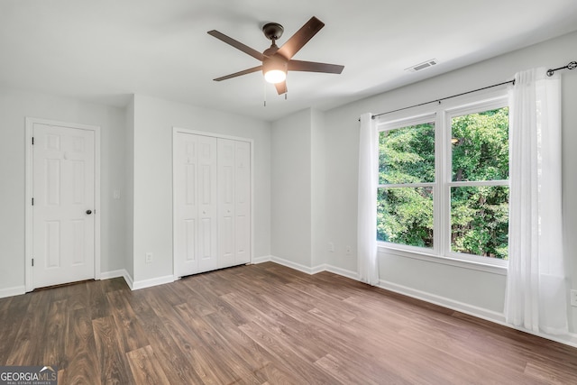 100 Castlebrook Chase, Tyrone, GA 30290 - unfurnished bedroom with dark wood-type flooring, a closet, and a ceiling fan