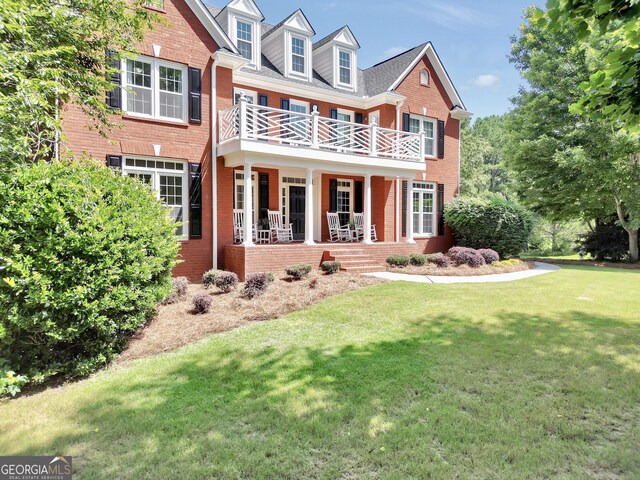 100 Castlebrook Chase, Tyrone, GA 30290 - view of front facade with a balcony, brick siding, a front yard, and a porch