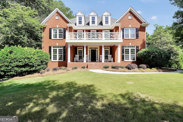 100 Castlebrook Chase, Tyrone, GA 30290 - view of front of home featuring a balcony, a porch, brick siding, and a front lawn