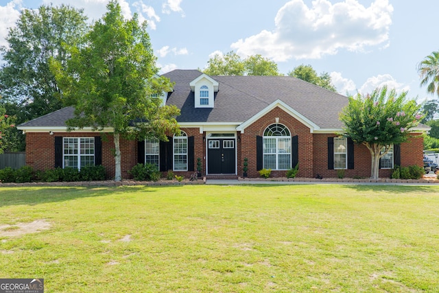 1112 Old Meadow Rd, Valdosta, GA 31605 - view of front facade featuring a front yard, brick siding, and roof with shingles