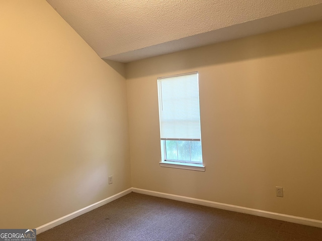 2561 Lancewood Ln, Lithonia, GA 30058 - spare room with dark colored carpet and a textured ceiling