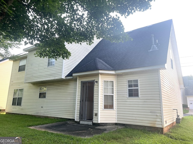 2561 Lancewood Ln, Lithonia, GA 30058 - rear view of property featuring a lawn and roof with shingles