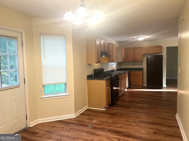 2561 Lancewood Ln, Lithonia, GA 30058 - kitchen featuring black appliances, under cabinet range hood, a chandelier, dark wood finished floors, and dark countertops