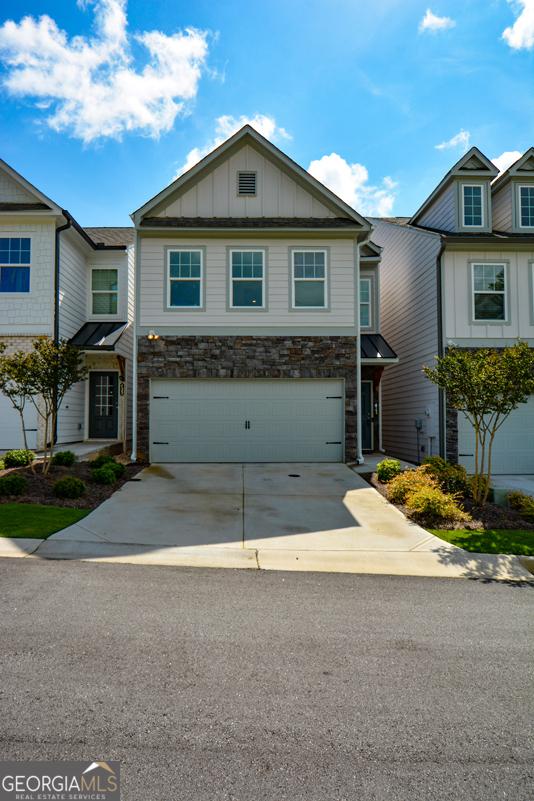 428 Whitetail Cir, Canton, GA 30115 - multi unit property featuring board and batten siding, concrete driveway, a garage, and stone siding