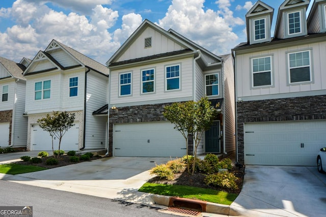 428 Whitetail Cir, Canton, GA 30115 - view of front facade featuring board and batten siding, driveway, stone siding, and an attached garage