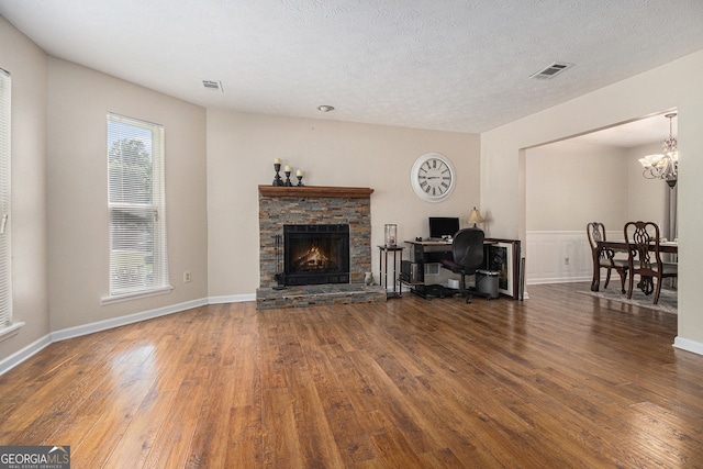 5086 N Woodbridge Trl, Stone Mountain, GA 30088 - living area featuring wood finished floors, a chandelier, a fireplace, and an office area