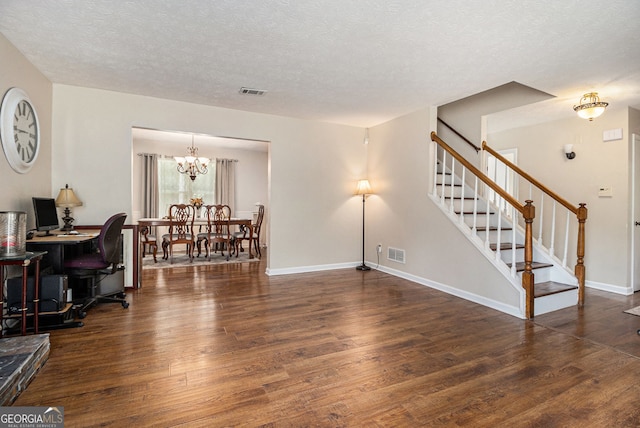 5086 N Woodbridge Trl, Stone Mountain, GA 30088 - living area with wood finished floors, stairway, a chandelier, and a textured ceiling