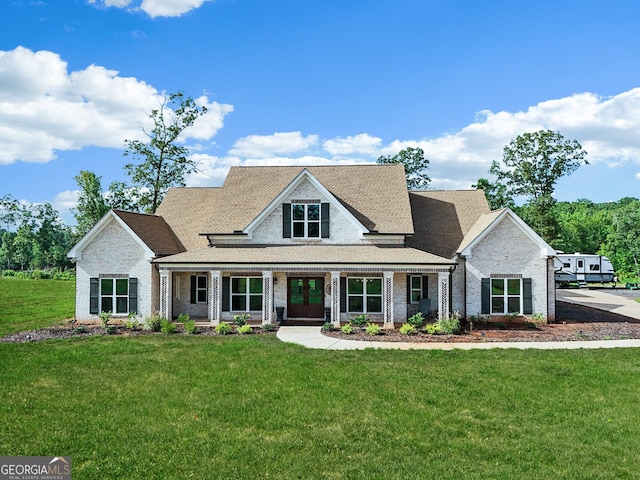 357 Old Driver Rd, Whitesburg, GA 30185 - view of front facade featuring a front yard, brick siding, a shingled roof, and french doors