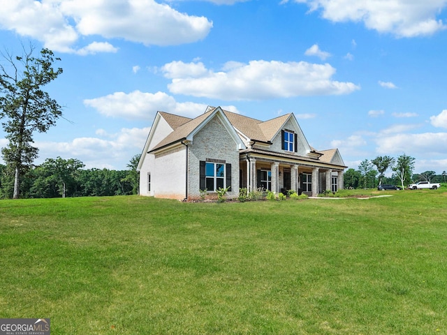 357 Old Driver Rd, Whitesburg, GA 30185 - view of front facade featuring a front yard, covered porch, brick siding, and stone siding
