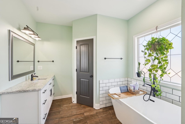 357 Old Driver Rd, Whitesburg, GA 30185 - bathroom featuring vanity, a soaking tub, wood finished floors, and tile walls