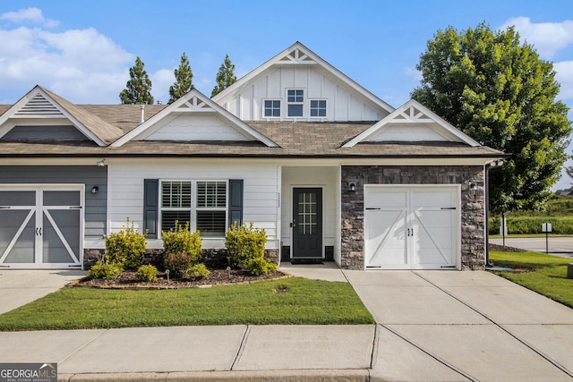 111 Point View Dr, Canton, GA 30114 - craftsman house featuring concrete driveway, board and batten siding, stone siding, and a front yard