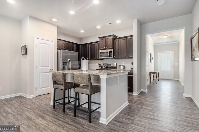 111 Point View Dr, Canton, GA 30114 - kitchen with appliances with stainless steel finishes, dark wood-type flooring, a kitchen bar, dark brown cabinetry, and recessed lighting