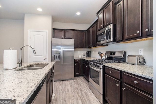 111 Point View Dr, Canton, GA 30114 - kitchen with appliances with stainless steel finishes, light stone countertops, dark brown cabinets, light wood-style floors, and recessed lighting