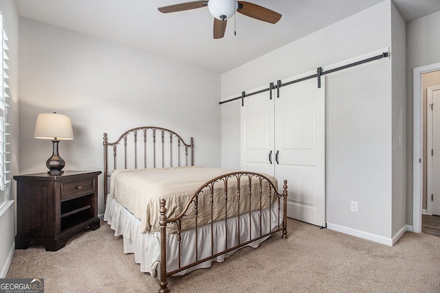 111 Point View Dr, Canton, GA 30114 - bedroom with a barn door, carpet floors, and a ceiling fan