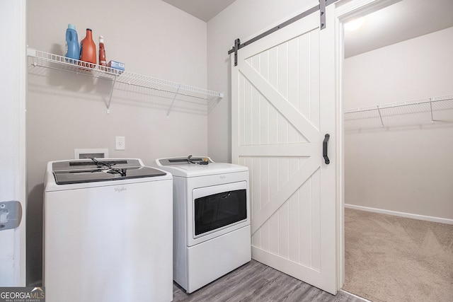 111 Point View Dr, Canton, GA 30114 - laundry room with a barn door, washer and clothes dryer, and light wood-type flooring