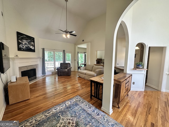 235 Pirkle Ct, Cumming, GA 30040 - living room with ceiling fan, high vaulted ceiling, wood finished floors, a fireplace, and arched walkways