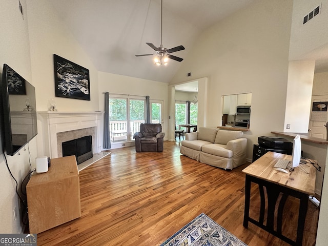 235 Pirkle Ct, Cumming, GA 30040 - living room featuring high vaulted ceiling, light wood-style flooring, a ceiling fan, and a premium fireplace