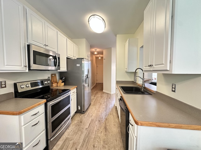 235 Pirkle Ct, Cumming, GA 30040 - kitchen featuring stainless steel appliances, light wood-style flooring, and white cabinets