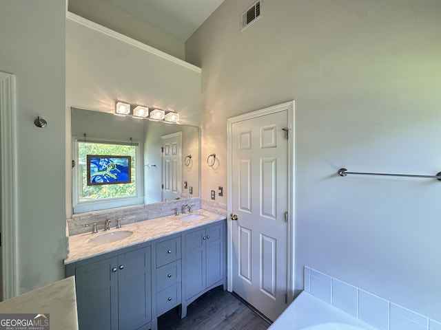 235 Pirkle Ct, Cumming, GA 30040 - bathroom featuring double vanity, a tub to relax in, and wood finished floors