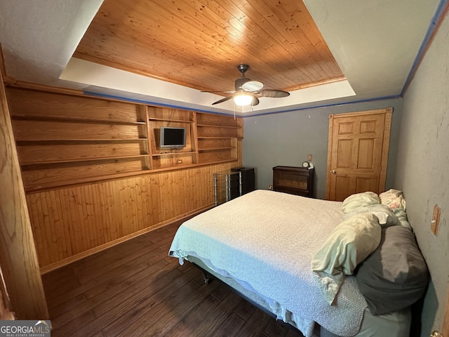 235 Pirkle Ct, Cumming, GA 30040 - bedroom with wooden ceiling, dark wood-style flooring, a tray ceiling, a ceiling fan, and wooden walls