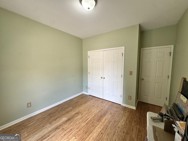 235 Pirkle Ct, Cumming, GA 30040 - unfurnished bedroom featuring wood finished floors and a closet