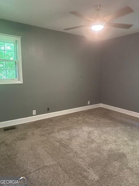 1408 Main St, Perry, GA 31069 - unfurnished room with dark carpet and ceiling fan