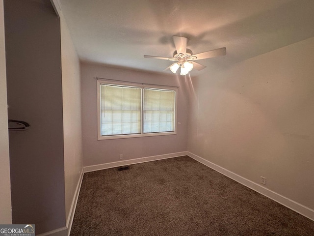 1408 Main St, Perry, GA 31069 - empty room featuring ceiling fan and dark carpet