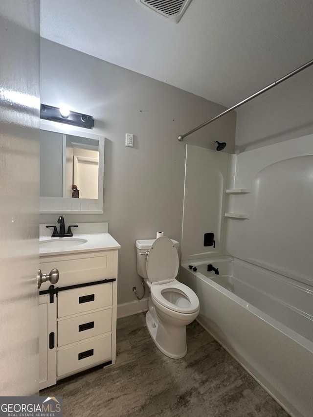 1408 Main St, Perry, GA 31069 - bathroom with wood finished floors, vanity, and shower / tub combination