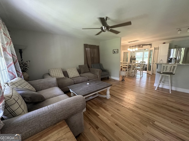 1408 Main St, Perry, GA 31069 - living room featuring ceiling fan, light wood-type flooring, and a chandelier