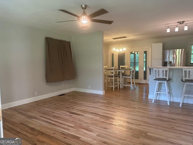 1408 Main St, Perry, GA 31069 - unfurnished living room with wood finished floors and a ceiling fan
