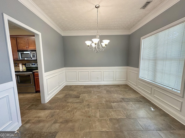 101 Riverchest Dr, Lagrange, GA 30240 - unfurnished dining area featuring a chandelier, wainscoting, a decorative wall, dark stone finish floors, and ornamental molding