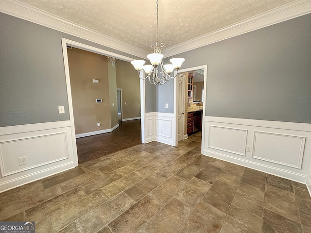 101 Riverchest Dr, Lagrange, GA 30240 - unfurnished dining area with dark stone finish floors, a chandelier, a textured ceiling, crown molding, and a decorative wall