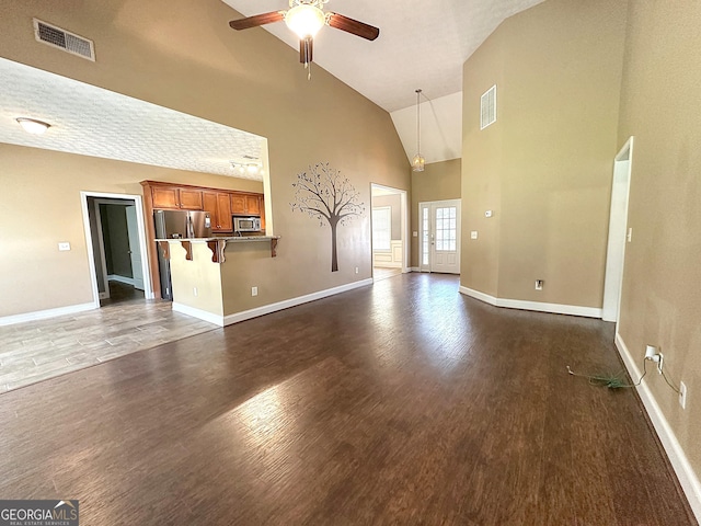 101 Riverchest Dr, Lagrange, GA 30240 - unfurnished living room with high vaulted ceiling, ceiling fan, and dark wood-type flooring
