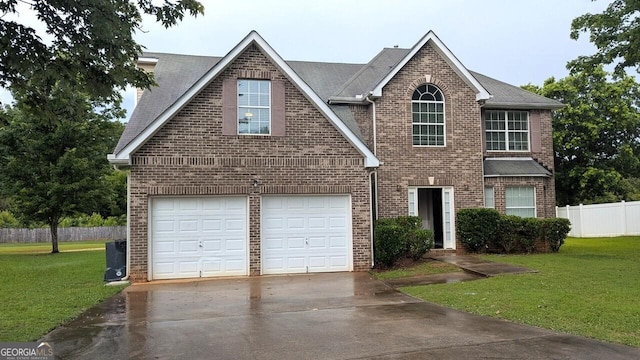 705 Mustang Ct, Hampton, GA 30228 - traditional-style house featuring driveway, brick siding, a garage, and roof with shingles