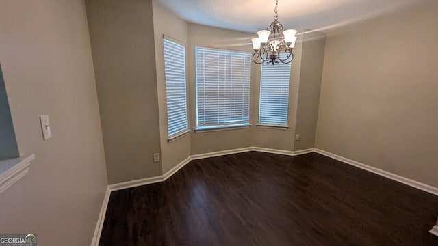705 Mustang Ct, Hampton, GA 30228 - spare room featuring dark wood-type flooring, a chandelier, and plenty of natural light