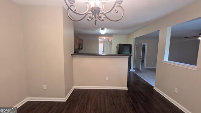 705 Mustang Ct, Hampton, GA 30228 - unfurnished dining area with dark wood-style flooring and a chandelier