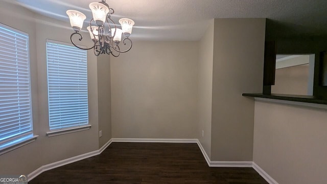 705 Mustang Ct, Hampton, GA 30228 - unfurnished dining area with a chandelier and wood finished floors