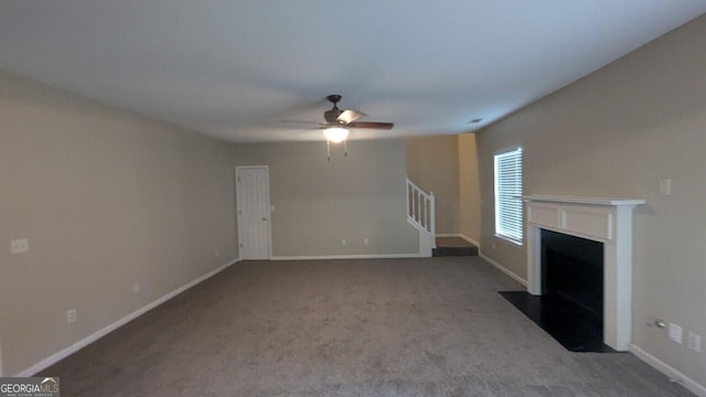 705 Mustang Ct, Hampton, GA 30228 - unfurnished living room with ceiling fan, a fireplace with flush hearth, stairs, and carpet