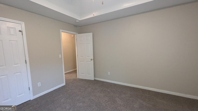 705 Mustang Ct, Hampton, GA 30228 - unfurnished bedroom with dark colored carpet and baseboards
