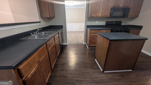 705 Mustang Ct, Hampton, GA 30228 - kitchen with black appliances, dark countertops, dark wood finished floors, a center island, and ornamental molding