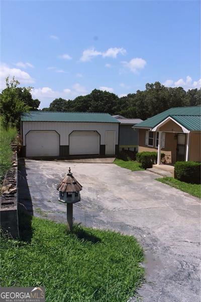 13 Travis, Rossville, GA 30741 - view of front facade featuring a fire pit and a detached garage
