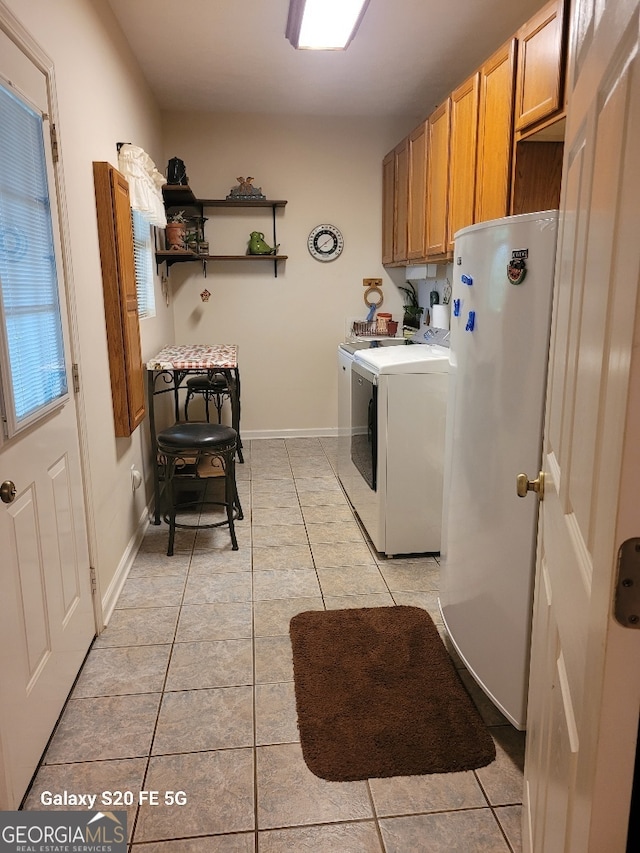 1904 S State Line Rd, Lagrange, GA 30240 - laundry room featuring light tile patterned floors, cabinet space, and independent washer and dryer