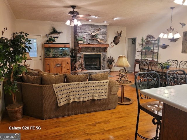 1904 S State Line Rd, Lagrange, GA 30240 - living area with ceiling fan, a fireplace, a chandelier, ornamental molding, and wood finished floors