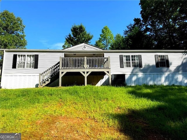 1570 Dean Mountain Rd, Cleveland, GA 30528 - back of property with a wooden deck, a lawn, and stairway